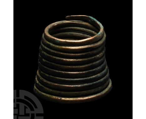 Central Europe, 2nd-1st millennium B.C. Formed from a round-section rod with tapered ends wound in a tapering coil.  23.16 gr