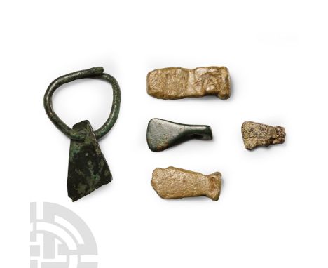 1st-4th century A.D. Comprising: three lead axes; one bronze with rounded blade; one sheet-bronze with round-section loop.  1