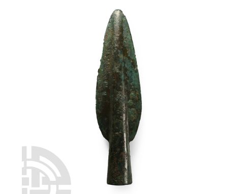 Late 2nd millennium B.C. With flared socket developing to a midrib in a leaf-shaped blade; opposed lateral holes to accept at