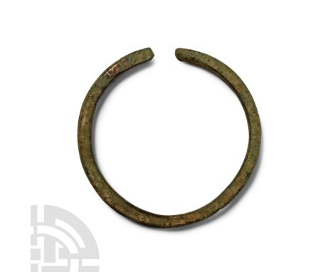 Late Bronze Age, 1st millennium B.C. Square in section with rounded outer face, transverse notches to the terminals.  65 gram