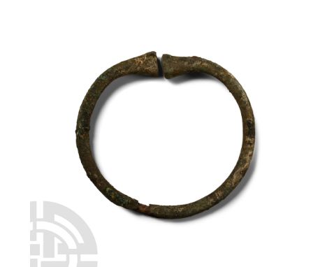 Late Bronze Age, 1st millennium B.C. Round-section shank with opposed trumpet-shaped finials.  37 grams, 72 mm (2 3/4 in.). [