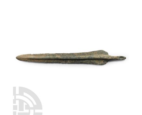 Circa 1000 B.C. With rounded shoulders and square-sectioned mid-rib running to the blade tip; short tang with fastening hole.