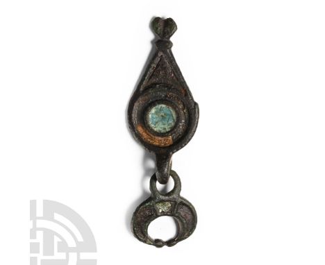 Circa 2nd century A.D. Composed of a pelta-shaped pendant (lunula) attached to a drop hanger decorated with concentric circle