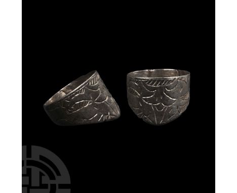 Circa 14th century A.D. Penannular with butted ends to the hoop, triangular extension with hatched fleur-de-lys motif in low 