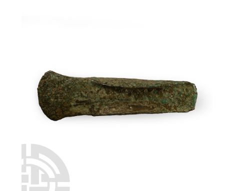 Britain, 2nd millennium B.C. Lentoid-section body, crescentic blade and square butt, lateral flanges on both faces. Cf. a sim