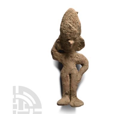 12th-14th century A.D. or later. Hand-modelled Chancay(?) figure of a standing female with left hand on her hip and right han