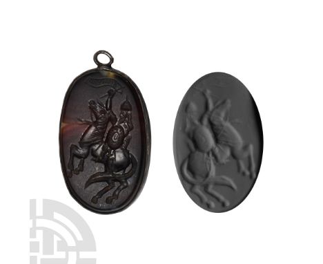 16th-17th century A.D. Banded agate plaque in frame with dense rosette and foliage to reverse; intaglio rider on rearing hors