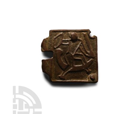 11th-12th century A.D. Square in plan with attachment arms to forward edge; high-relief design of a warrior with sword and sh