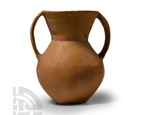 Neolithic Period, 3rd millennium B.C. Comprising a biconical body and tall flared neck, two broad strap handles to the sides.