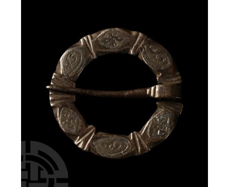 13th century A.D. The hoop formed flat with six bulbs separated by notched bars, each bulb with scrolled tendril or pelletted