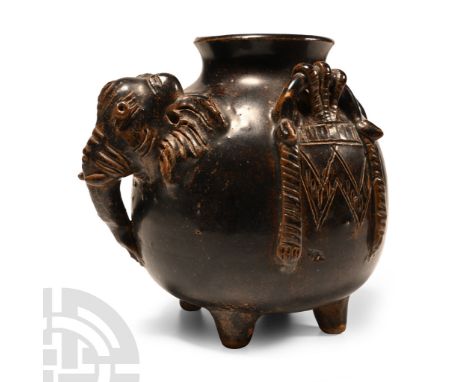 19th-20th century A.D. Bulbous in profile with four stub legs and broad flared mouth, applied detailing of an elephant's head