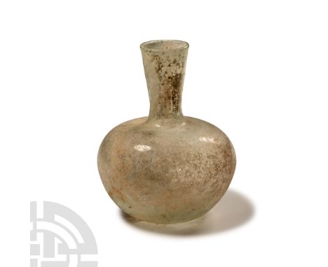 4th century A.D. Flask with squat bulbous body and broad shoulder, slender cylindrical neck with flared rim, dimpled base; ir