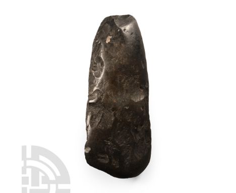 Neolithic Period, circa 4th-3rd millennium B.C. Of biconvex section with narrow butt and broad gently curved edge. Cf. MacGre