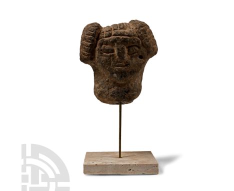 Circa 600 B.C. or later. Carved in the round with hatched hair and low-relief facial features; mounted on a custom-made stand
