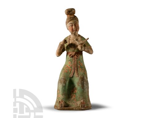 Tang Dynasty, 618-907 A.D. or later. Dressed in floor-length courtly dress with floral decoration, sash with a bow to the wai