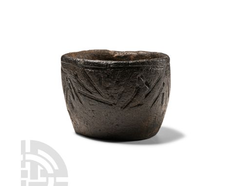 Early 3rd millennium B.C. A squat vessel with flat base and barrel-shaped body with incised band below the rim, impressed arr