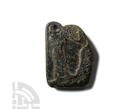 Early 2nd millennium B.C. Polished stone fragment with frieze depicting a seated ruler wearing a floor-length robe, one arm r