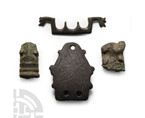 6th-11th century A.D. Comprising: a stirrup mount; two fragments of footplate, each from a cruciform brooch; bronze fitting (