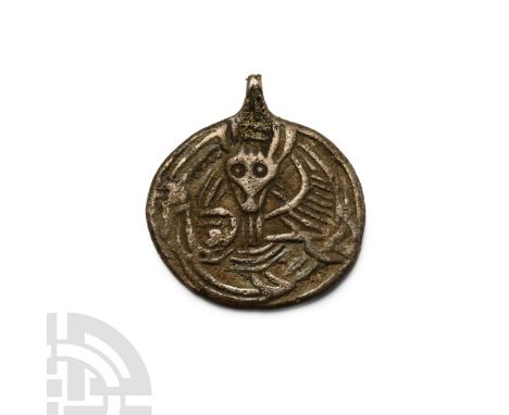 Circa 9th-11th century A.D. With integral loop, border enclosing a low-relief image of a male facing mask between two birds e