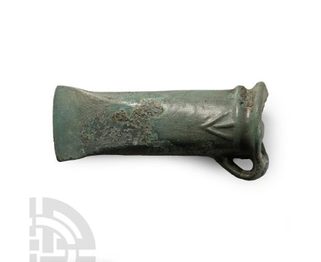 Central Europe, 2nd-1st millennium B.C. A cast looped and socketted axe head with straight edge, collar to mouth and lateral 