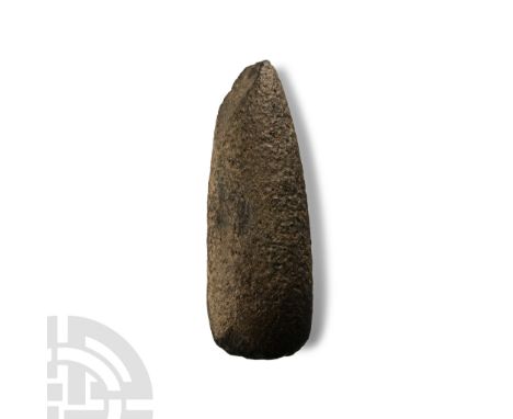 Neolithic Period, circa 4th-3rd millennium B.C. Ellipsoid in section with gently curved cutting edge; butt chipped, pecked su