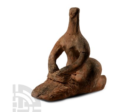 20th century A.D. Modelled in the round in crouching pose with hands resting on the handstone of a saddle quern; repaired.  2