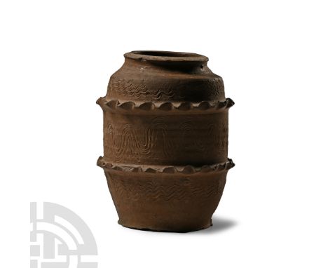 Qing Dynasty, 1644-1911 A.D. Barrel-shaped with carinated rim, two raised bands of piecrust ornament and low-relief scale det