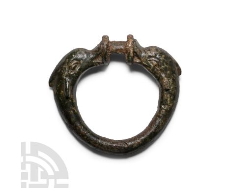 1st-2nd century A.D. Comprising a D-section hoop with shoulders formed as opposed dolphins holding in their mouths a pair of 