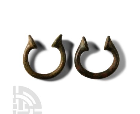 19th century A.D. Group of two penannular round-section bracelets with clubbed ends.  150 grams total, 59-63 mm (2 3/8 - 2 1/