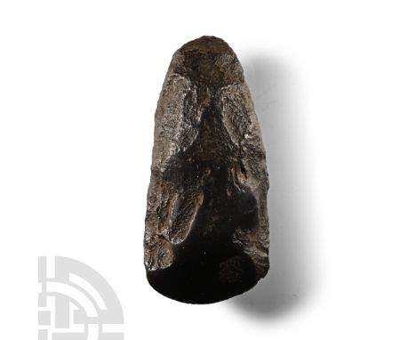Neolithic Period, circa 4th-3rd millennium B.C. Ellipsoid in section with rounded butt, curved and polished cutting edge.  58