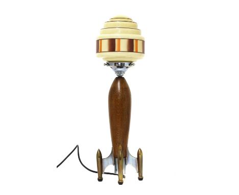 An Art Deco rocket table lamp,with a turned oak body, raised on brass feet, with a cream-coloured glass shade with orange geo