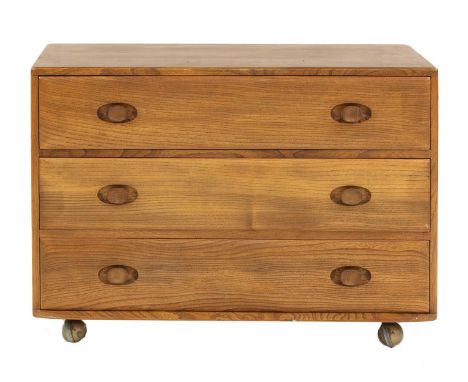 An Ercol elm chest of drawers,1960s, with three drawers with turned handles, on plastic castors,91.5cm wide48cm deep66cm high