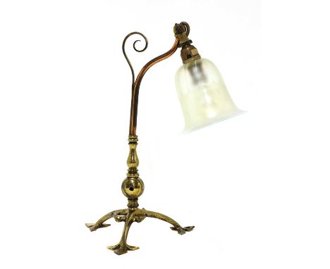 An Arts and Crafts copper and brass table lamp,designed by W A S Benson, with a hinged mount, stamped 'Benson', with scrolled