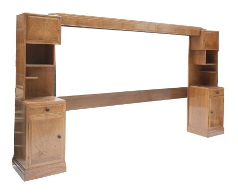 An Heal &amp; Son Art Deco walnut headboard,of stepped form, flanked on both sides by a cabinet over two shelves, over a beds