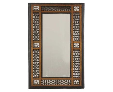 An Aesthetic Movement Moorish mahogany mirror,c.1900, possibly retailed by Liberty &amp; Co., the frame with ebonised bevelle