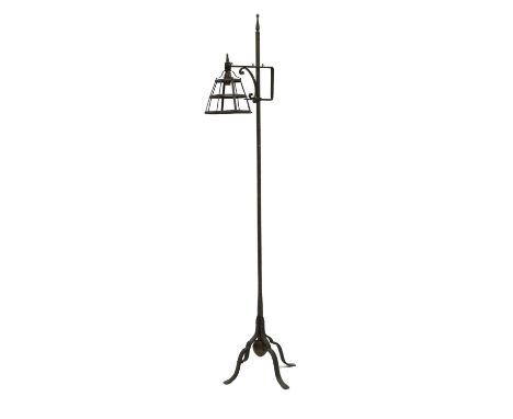 An Arts and Crafts wrought iron standard lamp,with an adjustable lantern, the stand with a dumb weight, 161cm highCondition r