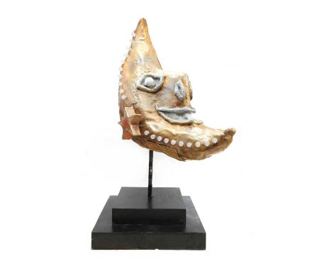 A fairground fixture,modelled as a grinning crescent moon, painted and sculpted fibreglass, decorated with lights, mounted on