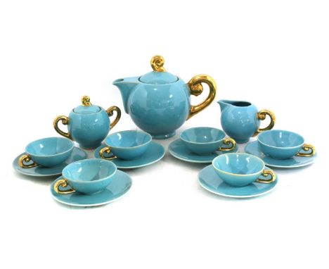 A Belgian blue-glazed tea service, designed by Roger Guerin, with gilt scroll handles, comprising:teapot,sugar bowl,cream jug