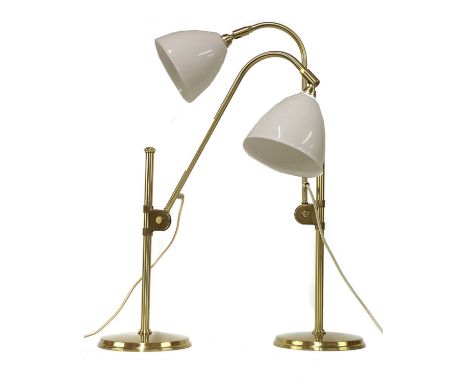 A pair of contemporary Bestlite lamps, with adjustable supports on columns, with white ceramic shades, stamped marks, adjusta