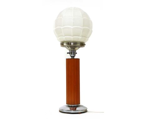 An Art Deco table lamp,  with a white globe shade, raised on a Bakelite column, on a shaped circular plinth, 47cm highProvena