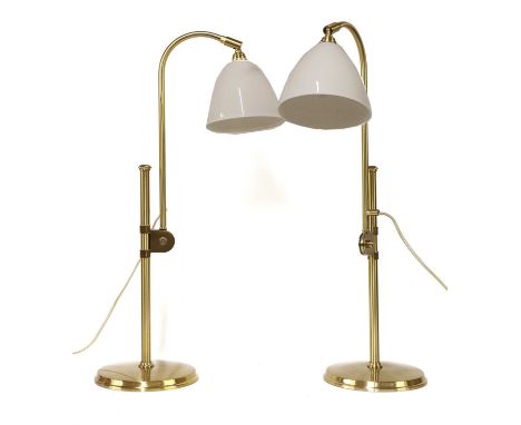 A pair of contemporary Bestlite lamps, with adjustable supports on columns, with white ceramic shades, stamped marks, adjusta