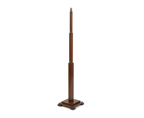 An Art Deco walnut 'Sky Scraper' standard lamp, with three stepped and fluted columns, raised on a stepped plinth, on ebonise