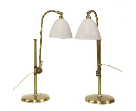 A pair of contemporary Bestlite lamps, with adjustable supports on columns, with white ceramic shades, stamped marks, adjusta