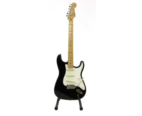 A 1989 Fender Stratocaster electric guitar,serial number E8****2, of conventional form with a black finish and white pickguar