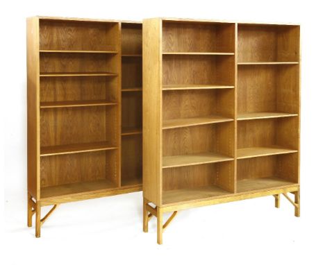 A pair of Danish light oak open bookcases,each with two tiers of adjustable shelves on raised supports,122cm wide26cm deep159