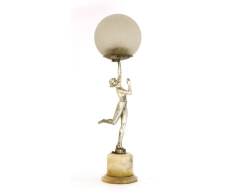 An Art Deco spelter and marble table lamp,modelled as a silvered figure holding a lamp,15cm diameter56cm high