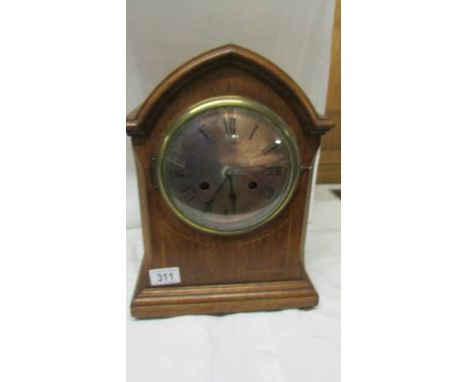 A mahogany inlaid eight day mantel clock.