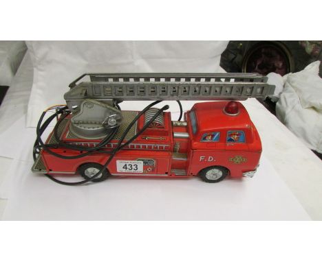 A Japanese tin plate 'Modern Toys' battery operated fire engine (no battery hand control).