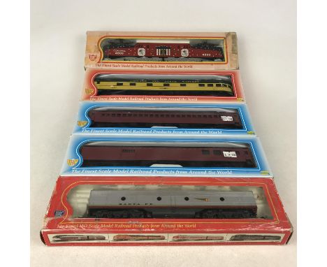 Five boxed IHC HO gauge models including E-8 B (powered) No 6103 and locomotive No 28485 plus three others.
