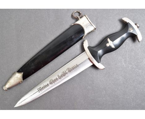 An original WWII Second World War Third Reich Nazi German waffen SS Officers dagger. The dagger having a wide steel pommel wi